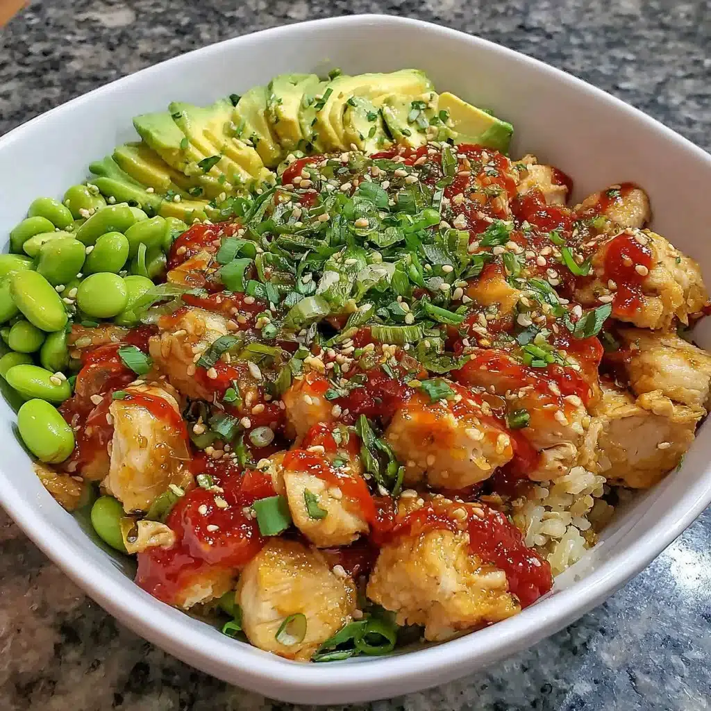 Protein Power Bowl with chicken, edamame, and avocado on a wooden table.