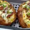 Delicious air fryer baked potatoes served on a plate with toppings