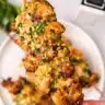 Garlic parmesan air fryer chicken skewers served on a platter garnished with herbs.